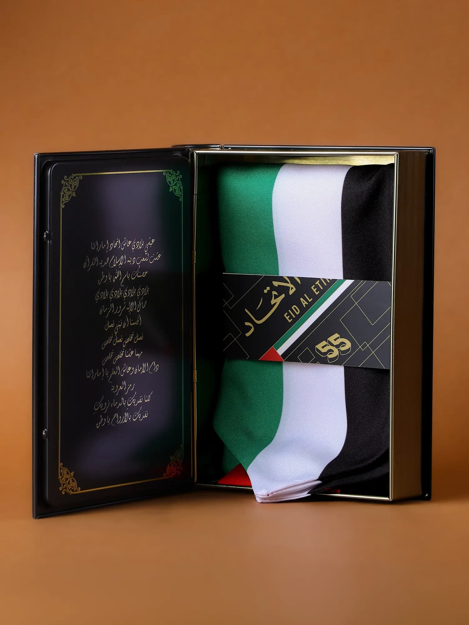 The box open, showing the scarf, notebook, pin and stickers